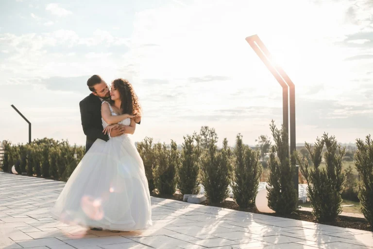 happy groom hugging his bride