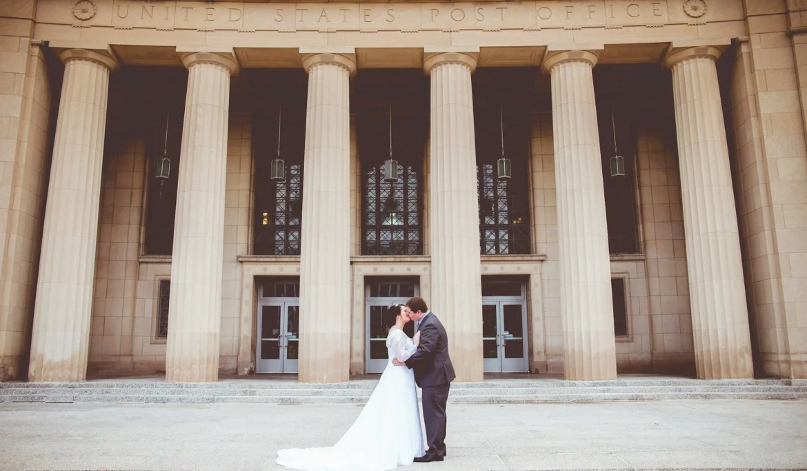bride and groom kissing on the courthouse steps after getting married