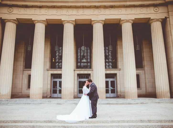 bride and groom kissing on the courthouse steps after getting married