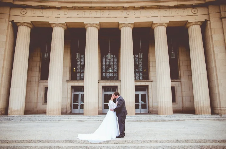 bride and groom kissing on the courthouse steps after getting married